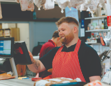 Butcher serving a customer
