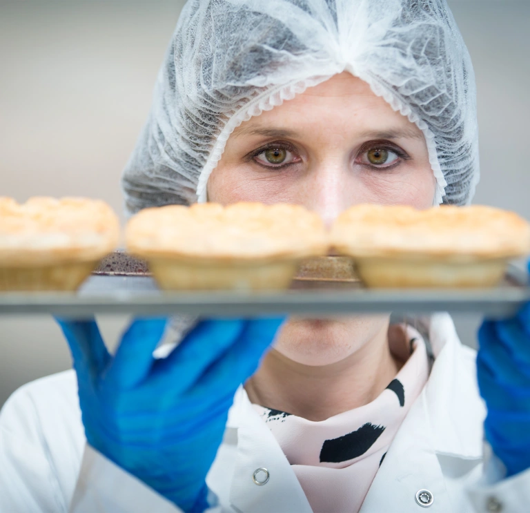Lady holding pies at innovaiton centre