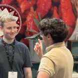 3 people at a stall chatting